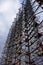 A complex structure of rusted metal and wires against a cloudy sky. Duga is a Soviet over-the-horizon radar station for an early