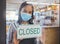 Compliance, safety and economic crisis closing store due to covid19 pandemic, sad and in debt. Small business owner