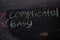 Complicated or Easy written with color chalk concept on the blackboard