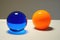 complimentary colored objects, like a blue ball and orange ball, sitting next to each other