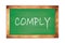 COMPLY text written on green school board