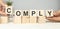 COMPLY word written on building blocks