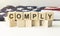 COMPLY word written on building blocks