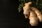Components of Asian cuisine, healthy food. Ginger close-up on a dark background on a wooden board