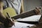 Composer holding pencil and writing lyrics in paper. Musician playing acoustic guitar