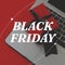 Composite of black friday text and gift with laptop on red background