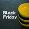 Composite of black friday text over yellow and black bowls on black background