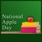 Composite of books and fresh apple on wooden table with national apple day text on green background