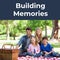 Composite of building memories text and caucasian parents and children sitting on blanket in park
