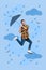 Composite collage image of excited funny funky man hang hold flying umbrella strong wind rainy weather clouds sky have