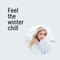 Composite of feel the winter chill text over happy caucasian woman in winter scenery