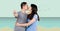Composite image of asian couple holding house keys kissing against beach in background
