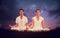 Composite image of attractive couple in white meditating in lotus pose