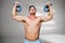 Composite image of bodybuilder holding kettlebells