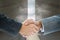 Composite image of business handshake against door