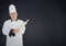 Composite image of Chef with rolling pin against navy background