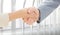 Composite image of closeup of shaking hands after business meeting