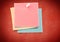 Composite image of colored Sticky Note against red background