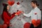 Composite image of couple holding red cracked heart shape