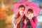Composite image of couple standing underneath an umbrella