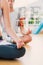 A Composite image of cropped couple in meditation pose at fitness studio