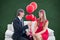 A Composite image of cute geeky couple with red balloons