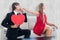 A Composite image of cute geeky couple with red heart shape