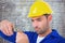 Composite image of electrician wearing hard hat while cutting wire