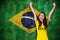 Composite image of excited football fan in brasil tshirt