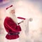 Composite image of father christmas writes a list