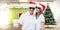 Composite image of festive couple smiling at camera