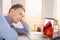 Composite image of focused businessman looking at laptop