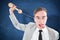 Composite image of geeky businessman being strangled by phone cord