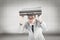 Composite image of geeky businessman holding his briefcase over head