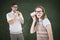 A Composite image of geeky hipster couple speaking with tin can phone