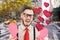 Composite image of geeky hipster crying and holding broken heart card