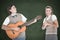 A Composite image of geeky hipster serenading his girlfriend with guitar