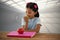 Composite image of girl eating granny smith apple at table