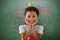 Composite image of girl with granny smith apple on head