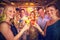 Composite image of group of friends toasting glass of cocktail in bar