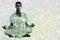 Composite image of handsome man in white meditating in lotus pose