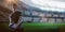 Composite image of handsome rugby player holding ball