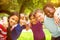 Composite image of happy children forming huddle at park