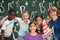 Composite image of happy children forming huddle at park