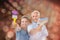 Composite image of happy couple holding paintbrushes smiling at camera
