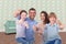 Composite image of happy family gesturing thumbs up
