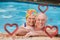 Composite image of happy mature couple in the swimming pool