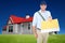 Composite image of happy postman delivering letter on white background