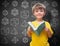 Composite image of happy pupil with book