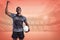 Composite image of happy sportsman with clenched fist holding rugby ball